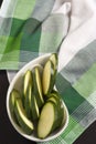 Zucchini sliced Ã¢â¬â¹Ã¢â¬â¹on Green Scottish plaid tablecloth.